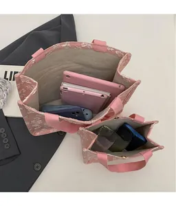 Overhead view showing storage capacity of large and small pink jacquard tote bags