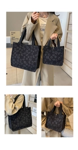 Detail of large and small black floral jacquard tote bags with canvas texture and handles