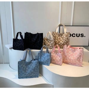 Detail of floral jacquard tote bags showing black, blue, pink and brown colors in two sizes