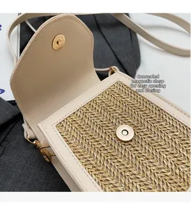 Detail of hand-woven crossbody bag showing the magnetic closure and cream leather texture
