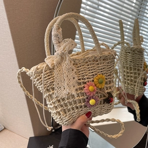 Handmade beige straw bucket bag with floral lace bow and woven shoulder strap