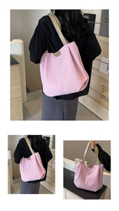 Detail view of pink tote bag showing the wide shoulder strap and leather fashion label