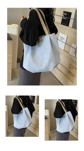 Detail view of light blue tote bag with contrasting khaki straps and matte finish
