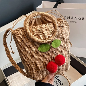 Handmade woven rattan crossbody bag with cherry decor and drawstring lining