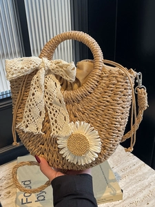 Handmade straw crossbody bag with white lace bow and large daisy flower decoration