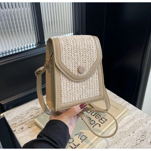 Detail view of the hand-woven V-shaped texture and button closure on the beige crossbody bag