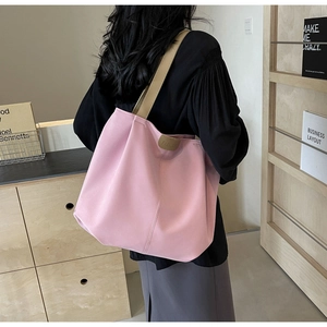 Rear view of a pink canvas tote bag with khaki straps showing its large size and drape