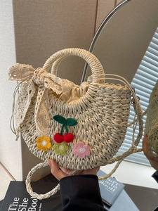 Handmade woven straw crossbody bag with crochet cherry floral decor and lace bow accent