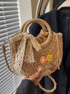Handwoven straw beach bag with 3D floral accents and delicate lace bow detail