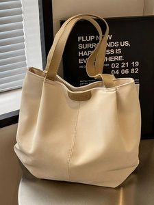 Cream white PU leather tote bag with tan handles and FASHION label in minimalist setting