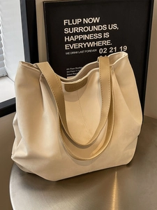 Fashionable creamy white large capacity tote bag with brown straps and fashion label decoration