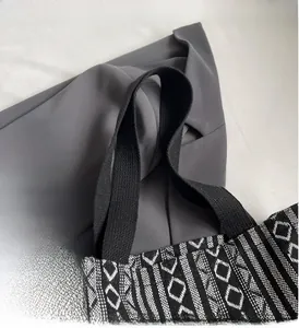 Close-up of bohemian tote bag weave with durable black handle and geometric patterns