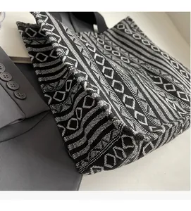 Detail of a large woven tote bag with black and white geometric ethnic pattern texture