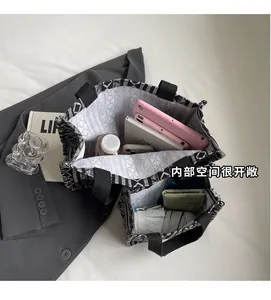 Interior view showing the large capacity of the woven tote bag with daily essentials