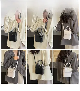 Detailed views of crocodile pattern crossbody bags with pearl bow charm and top handle