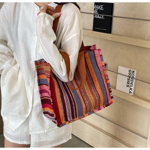 Detail of bohemian striped canvas tote bag showing spacious design and ethnic patterns