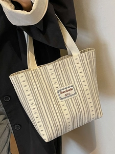 French style striped canvas tote bag with Nanxiaojie patch shown on a shoulder