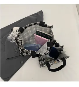 Internal layout of black and white plaid tote bags showing spacious storage capacity