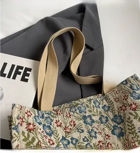 Macro shot of durable woven handle and floral jacquard fabric on the canvas tote bag
