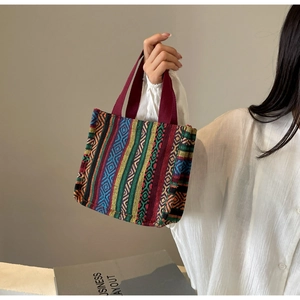 Close-up of ethnic woven pattern and canvas handles on a large capacity tote bag