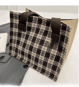 Close-up of checkerboard tote bag showing the weave texture and metal magnetic buckle
