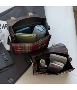 Detail of vintage plaid leather backpack showing large storage capacity for daily essentials