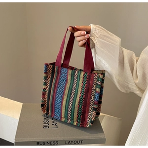 Close-up of geometric jacquard woven ethnic tote bag with bright colorful patterns