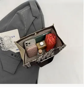 Interior view showing large capacity for wallet, phone and umbrella in a woven tote bag