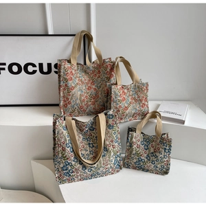 Detail of floral canvas tote bags set showing thick woven fabric and reinforced handles