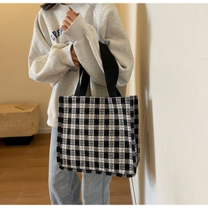 Detail of classic black and white checkered tote bag with durable fabric handles
