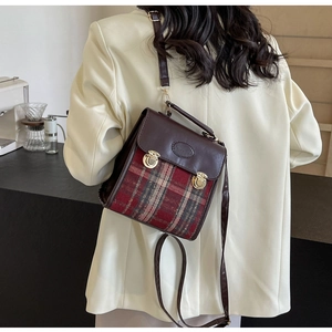 Detail of British retro plaid handbag with gold metal buckles and leather strap