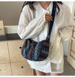 Sac à bandoulière ethnique avec broderie géométrique porté par un mannequin en chemise