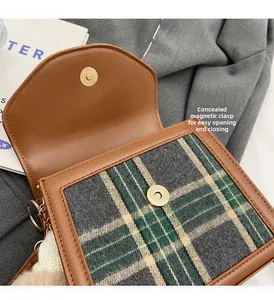 Detail view of the hidden magnetic clasp on the vintage plaid crossbody square bag