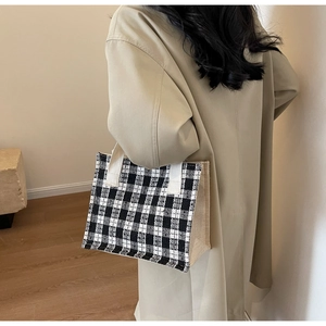 Detail of vintage plaid tote bag with textured black and white tweed and canvas contrast