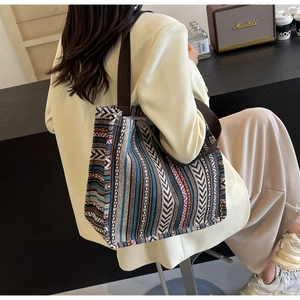 Detail of bohemian jacquard woven tote bag with colorful geometric patterns and durable handles