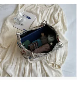 Spacious floral tote bag showing high capacity for essentials like wallets and cosmetics