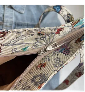 Detail of smooth silver zipper on a woven jacquard tote bag with ethnic patterns