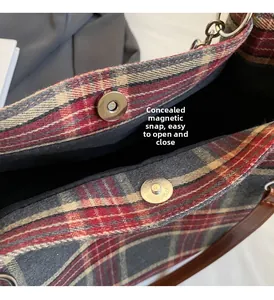 Close-up of the hidden magnetic buckle and plaid fabric on the stylish tote bag