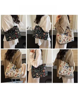 Detail of trendy butterfly print tote bags in black and beige with chain shoulder straps
