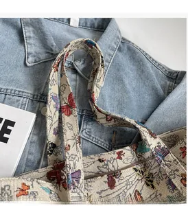 Close-up of durable canvas tote handle with colorful butterfly and floral prints