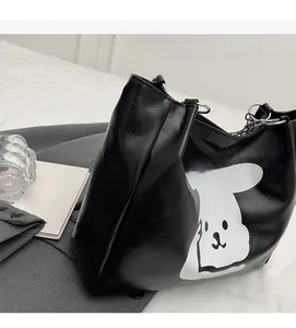 Detail of black PU leather tote bag with cartoon rabbit print and silver chain link strap