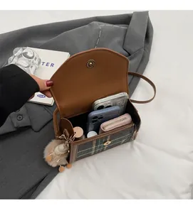 Detail showing spacious interior capacity of the retro plaid crossbody bag for phones