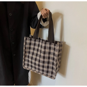 Detail of vintage plaid tote bag in brown and beige tweed with dual woven handles