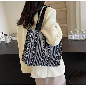 Detail of ethnic geometric pattern woven tote bag with thick canvas texture on shoulder