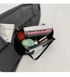 Detailed interior of high-capacity tote bag holding books, tablet and umbrella