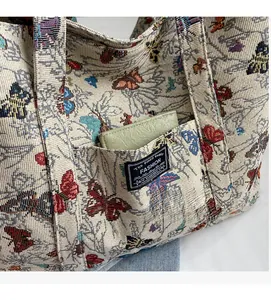 Close-up of front pocket on jacquard canvas tote bag with butterfly patterns