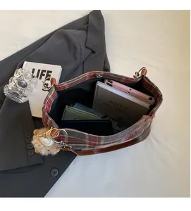 Spacious interior of retro plaid tote bag showing daily essentials and leather strap