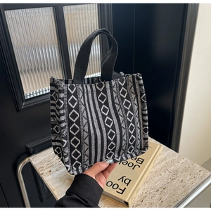 Detail of large canvas tote bag with black and white geometric ethnic weave pattern