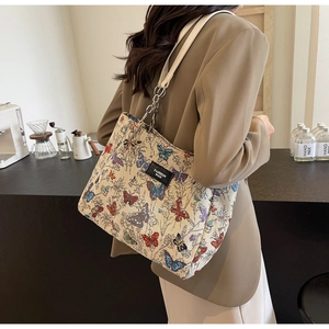 Detailed close-up of a vintage butterfly jacquard tote bag with chain strap and logo