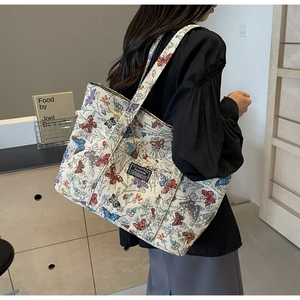 Detail of colorful butterfly jacquard pattern and fashion label on large canvas tote bag